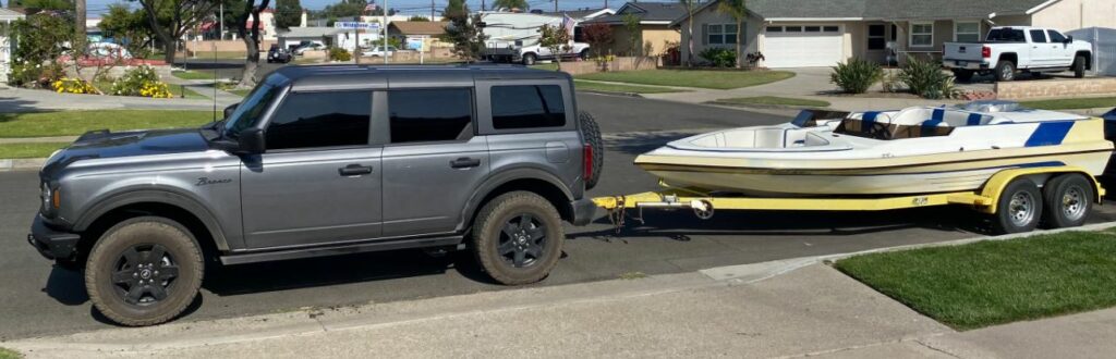 ford bronco towing a boat trailer