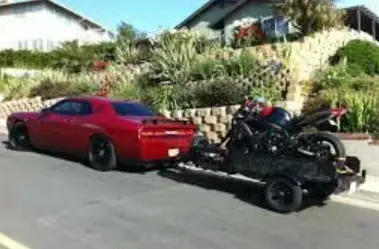 dodge challenger towing a motorcycle trailer