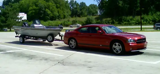dodge charger towing a boat trailer