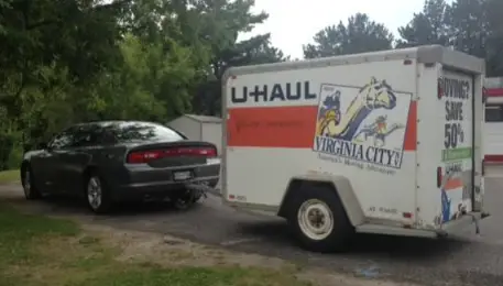 dodge charger towing a uhaul trailer